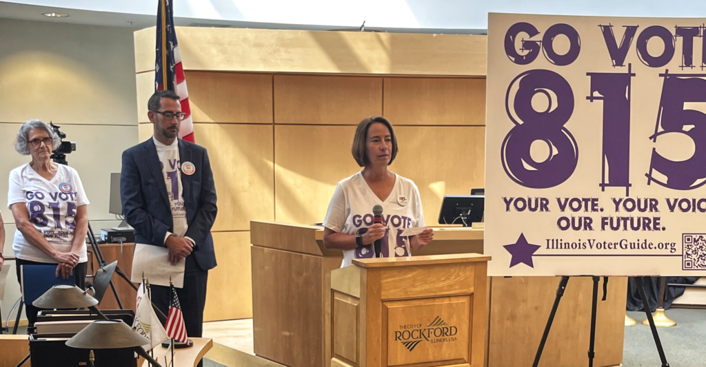 LWVGR Co-President Sue Theden discusses the purpose of the Go Vote 815 initiative as Mayor Thomas McNamara and LWVGR Voter Services Chair, Carol Davies look on.